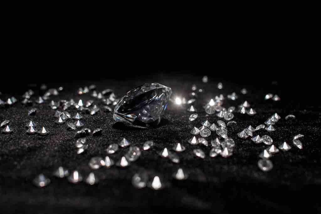 lab diamonds scattered across black background