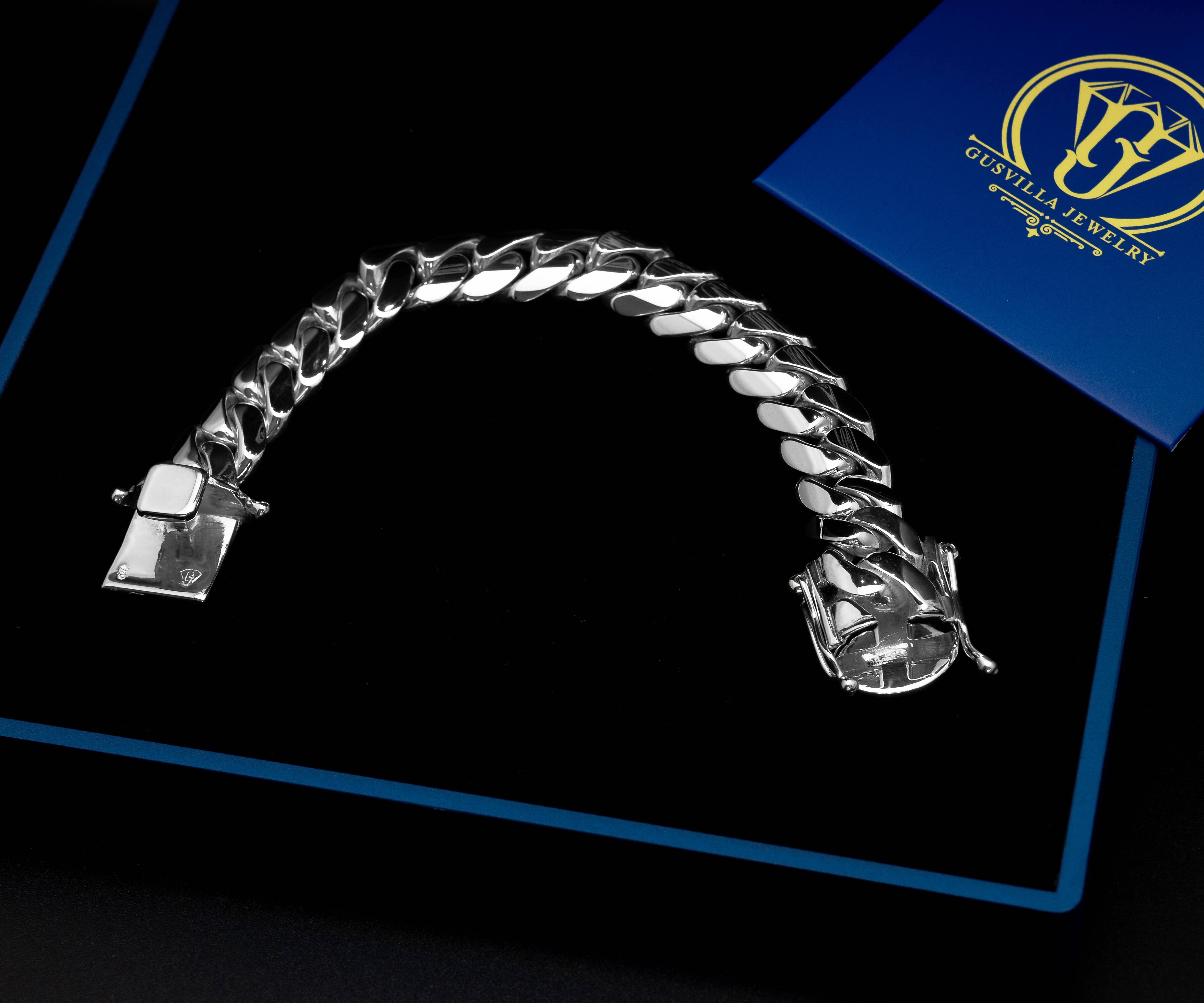 16 mm silver cuban link bracelet on table