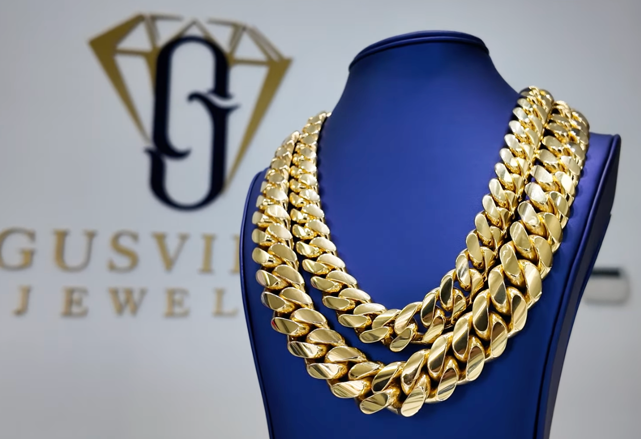 gold over silver chain laid over a solid gold chain. both were handmade at gusvilla jewelry