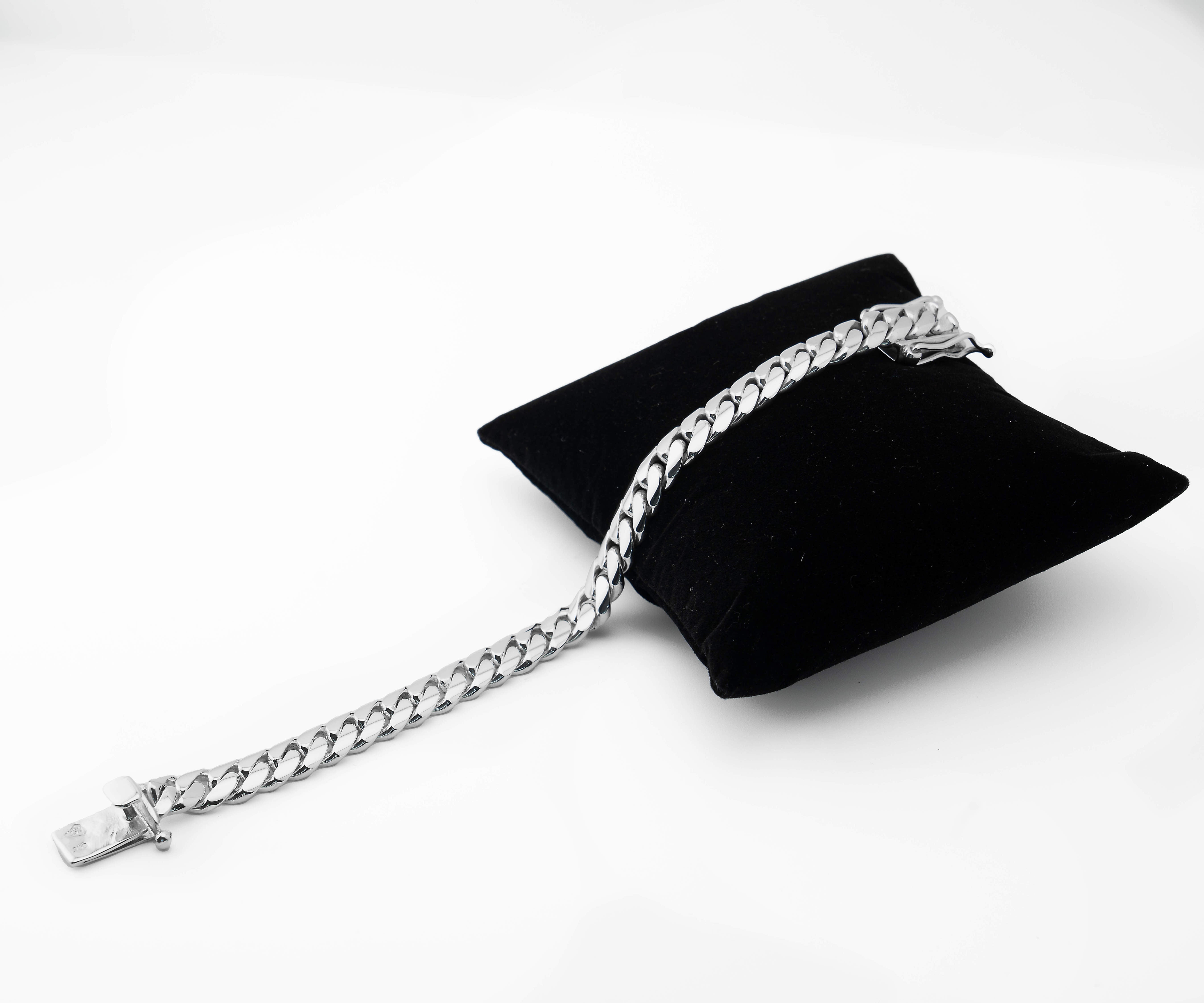 10 mm silver cuban link bracelet on black pillow