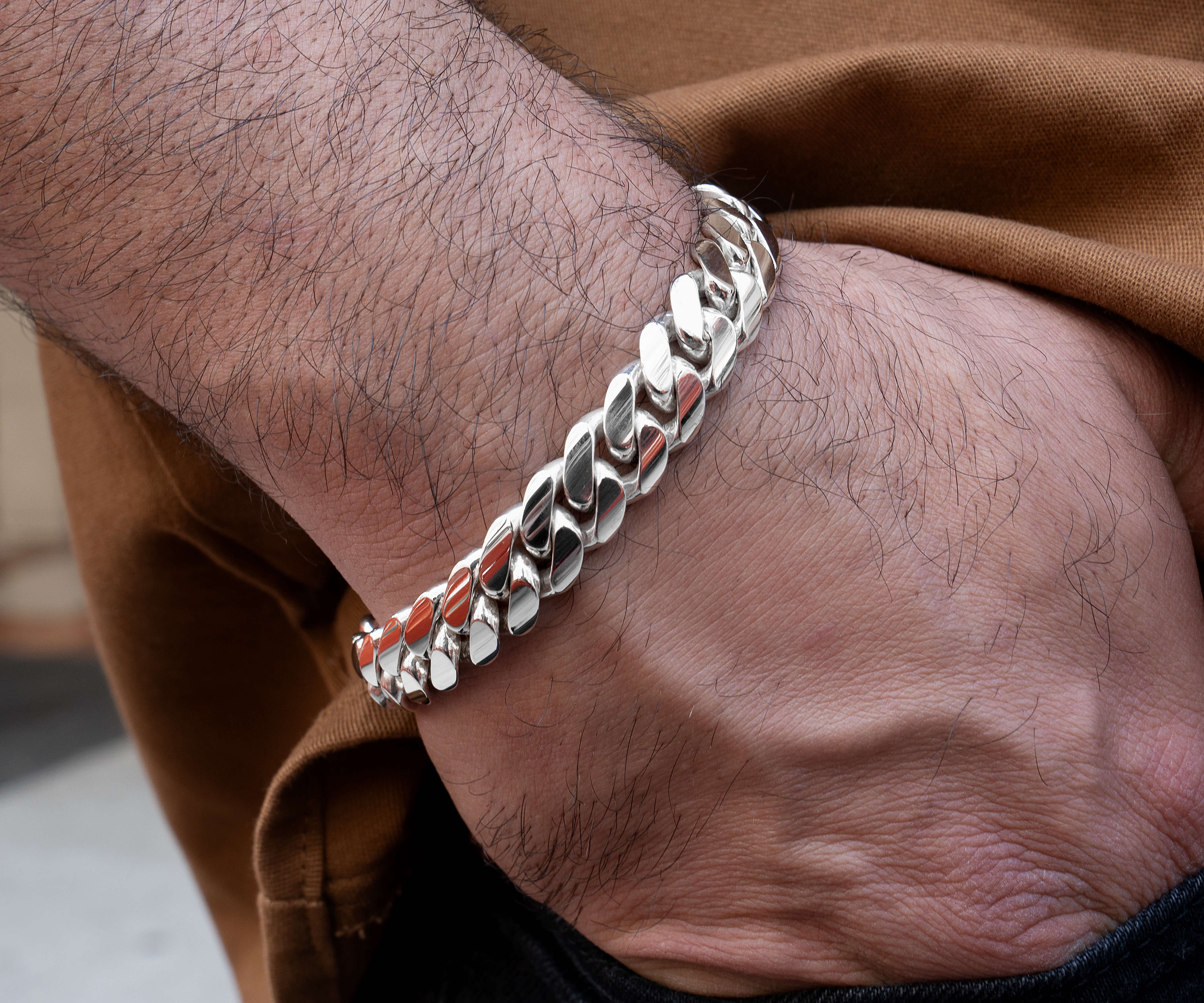 man wearing 12 mm silver cuban link bracelet