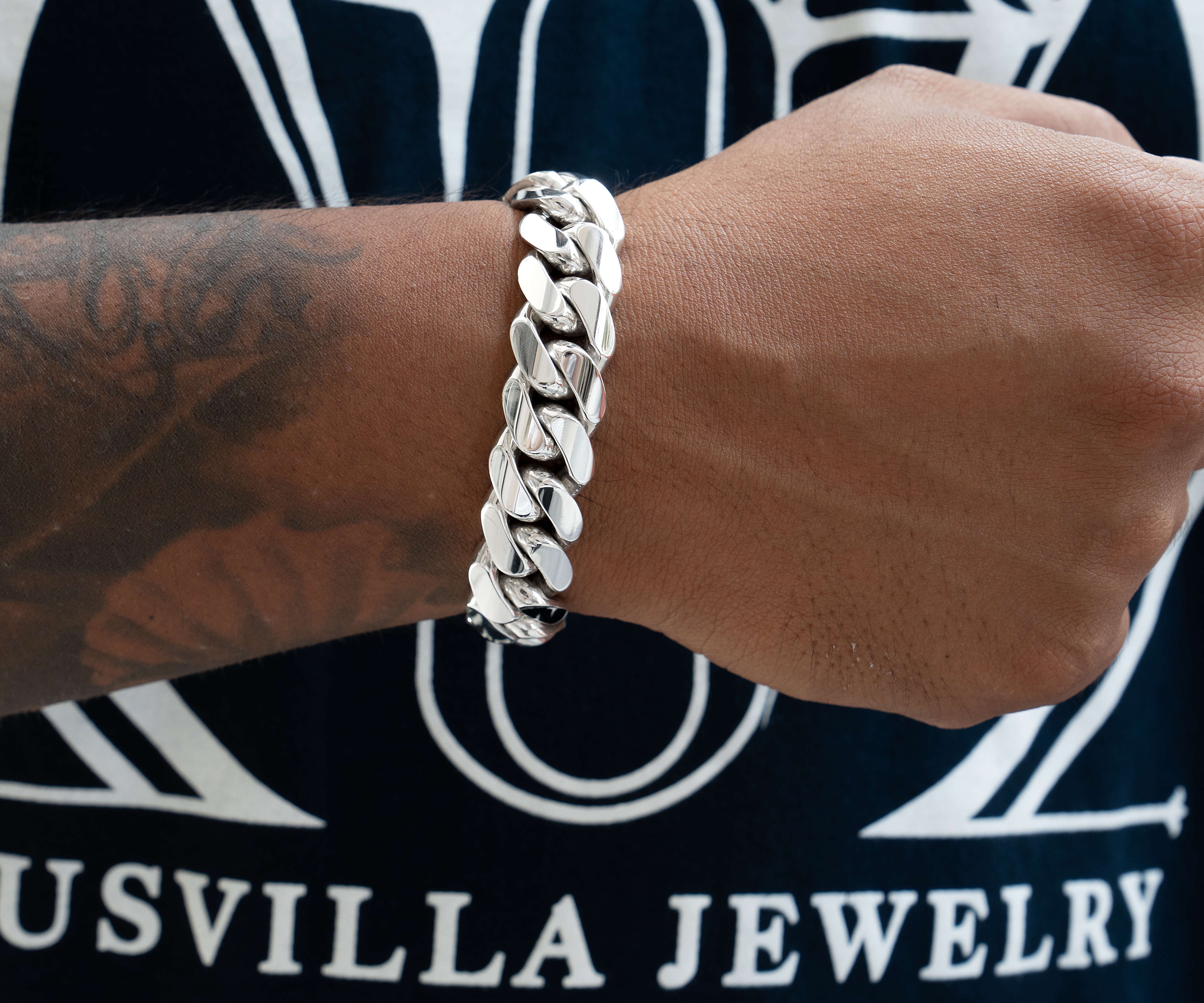 man wearing 16 mm silver cuban link bracelet